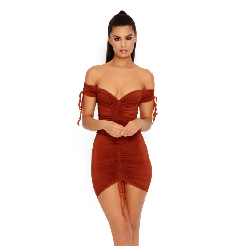 Pull On My Heartstrings Ruched Bardot Mini Dress in Rust sold by Oh Polly