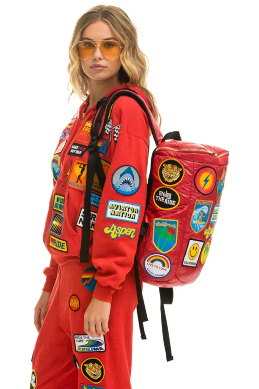 VINTAGE PATCH PUFFER BACKPACK - CHERRY GLOSSY sold by Aviator Nation