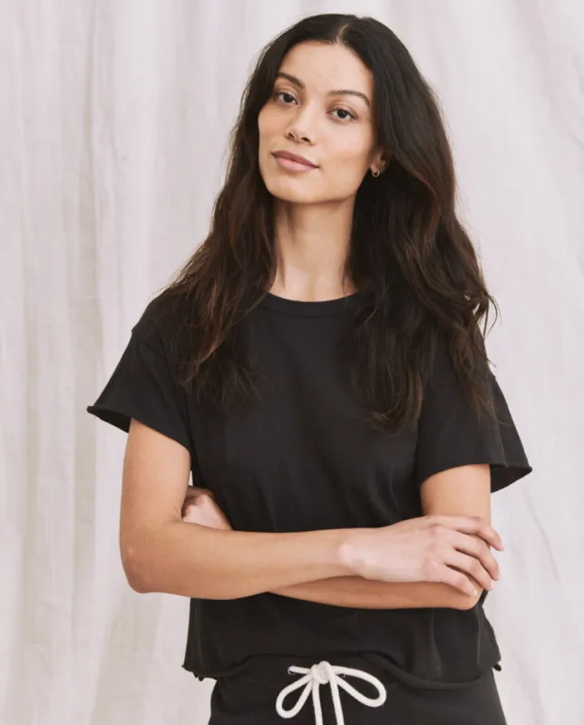The Crop Tee. Solid -- Almost Black sold by THE GREAT.