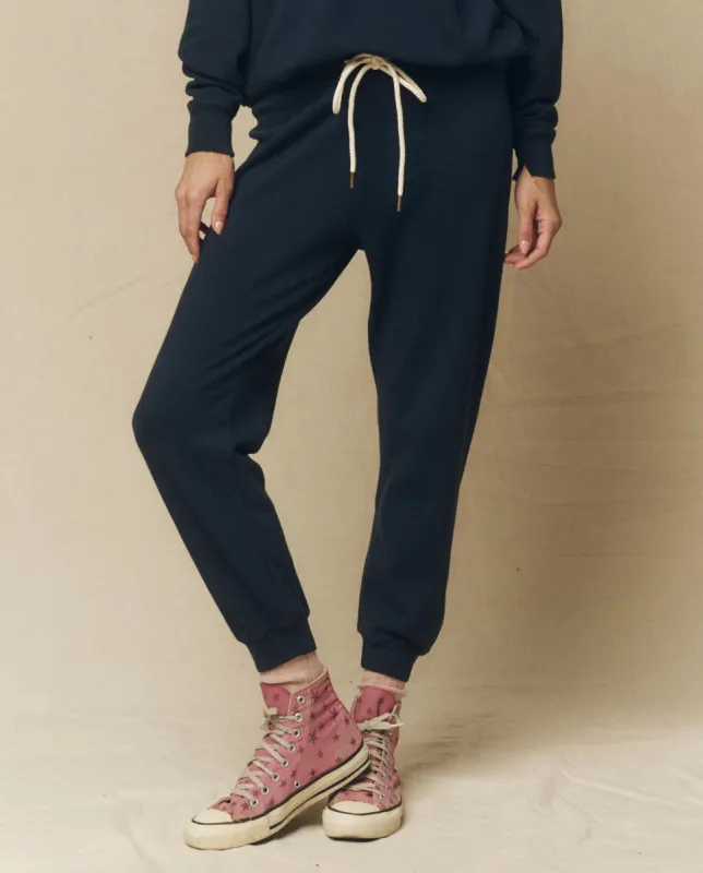 The Cropped Sweatpant. Solid -- True Navy sold by THE GREAT.