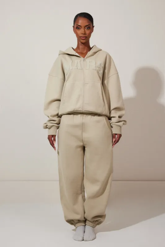 The Graphic Varsity Cuffed Joggers - Stone sold by MARS THE LABEL