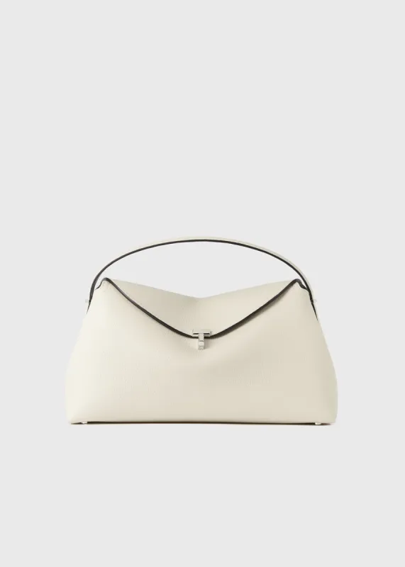 T-Lock grained-leather top handle milk sold by Toteme