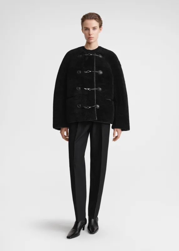 Teddy shearling clasp jacket black sold by Toteme