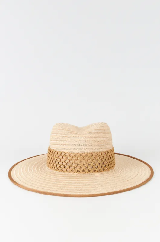 Natural straw hat with intricate band sold by DESTREE