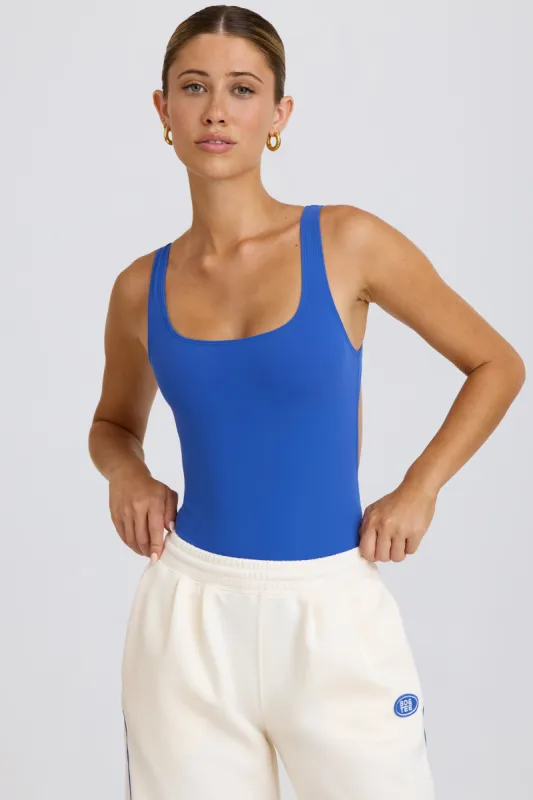 Soft Active Open-Back Bodysuit in Cobalt sold by Oh Polly