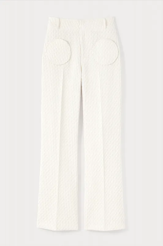 Ivory flutter flared pants with circular pockets sold by DESTREE
