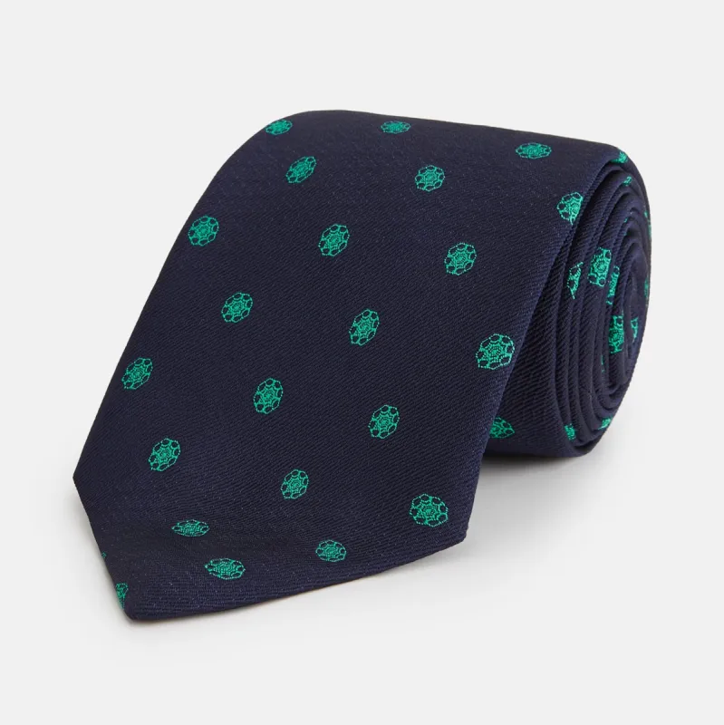 Green flower and navy silk tie sold by Turnbull & Asser