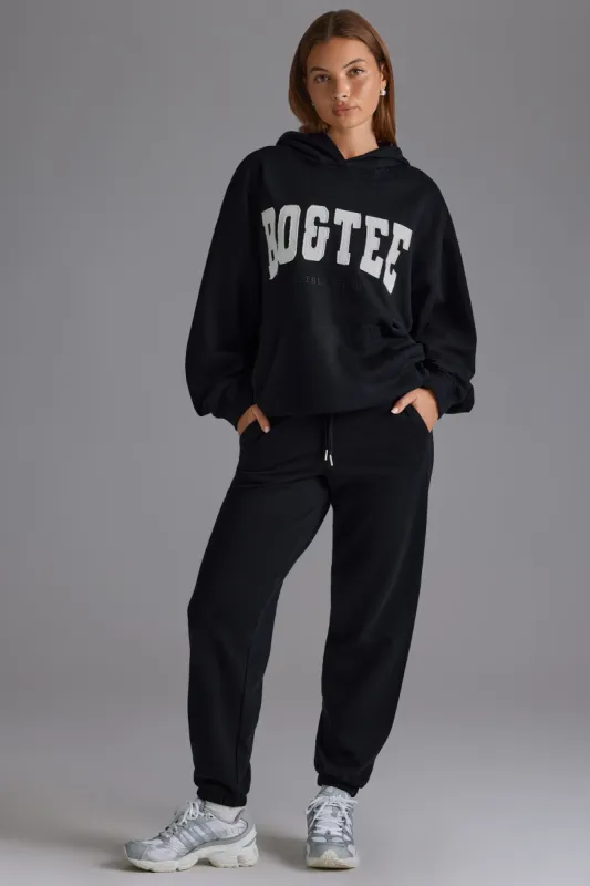 Petite Relaxed Mid-Rise Joggers in Black sold by Oh Polly