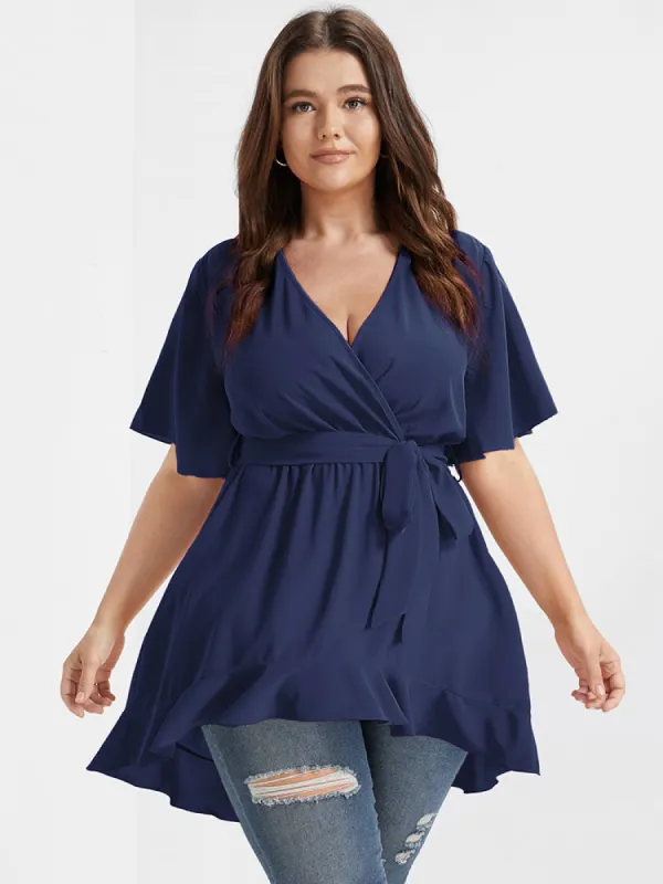 Solid Belted Asymmetrical Hem Flutter Wrap Blouse sold by Bloomchic