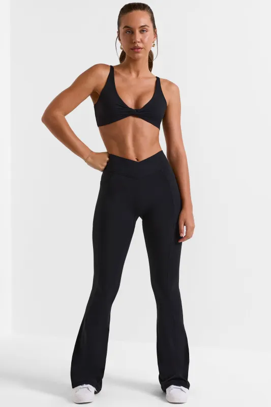 Soft Active Crossover Flared Trousers in Black sold by Oh Polly